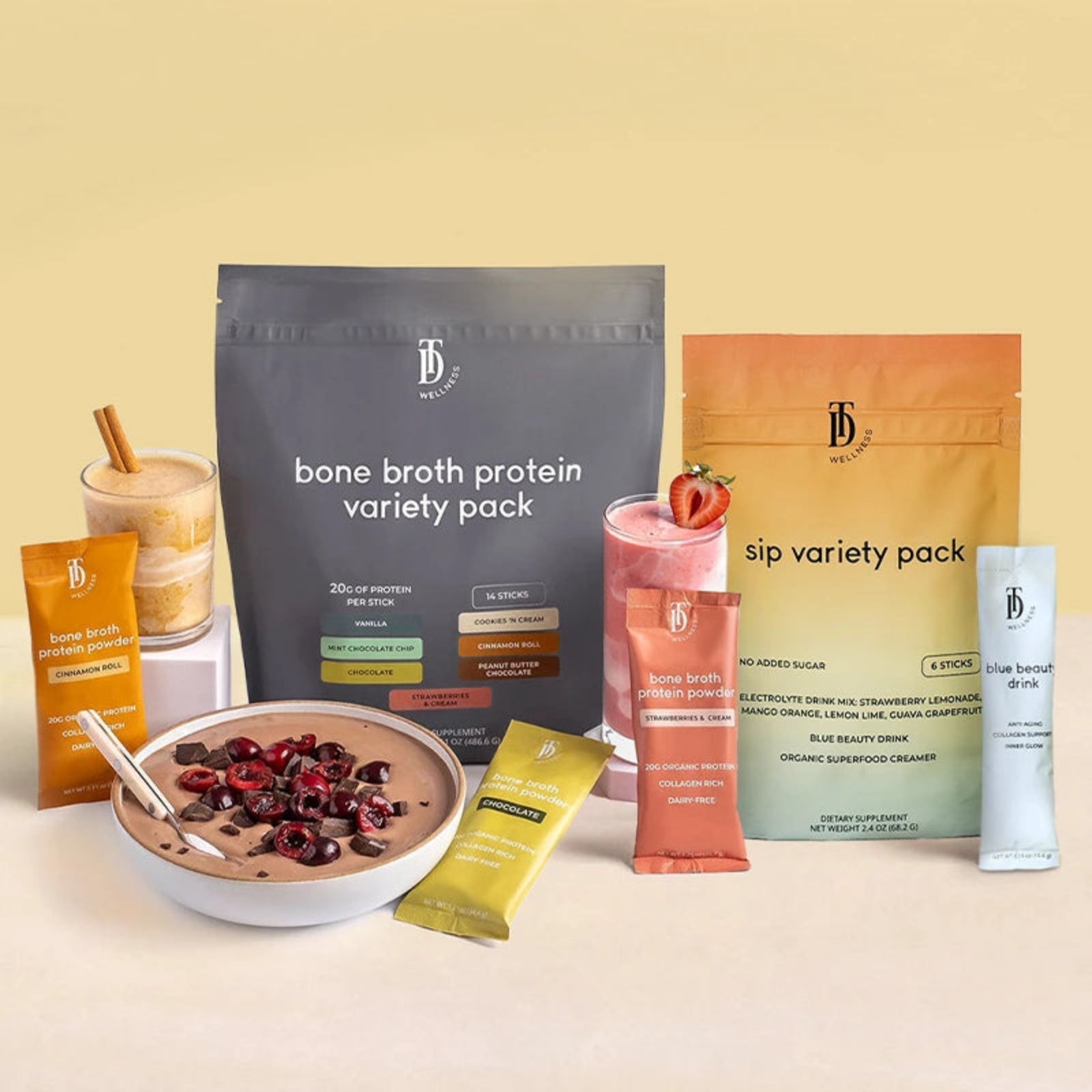 Collection of bone broth protein and sip variety packs on a beige background